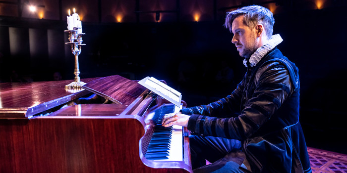 Cast member playing the piano.