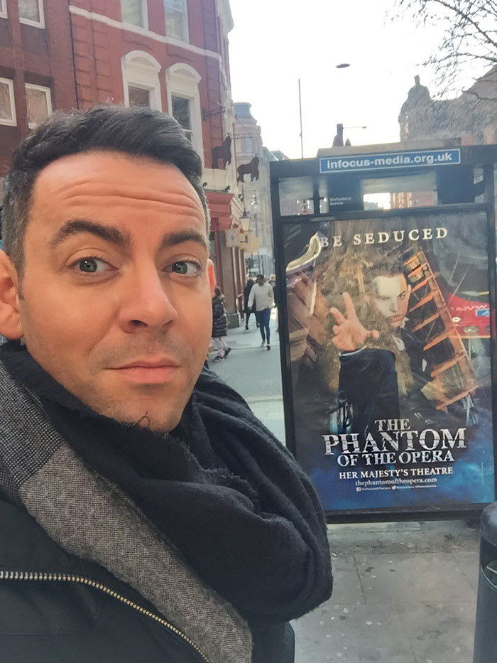 Ben Forster with a The Phantom Of The Opera poster